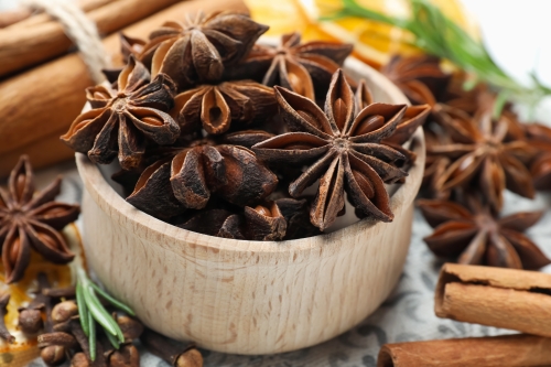 Star anise in wooden bowl.